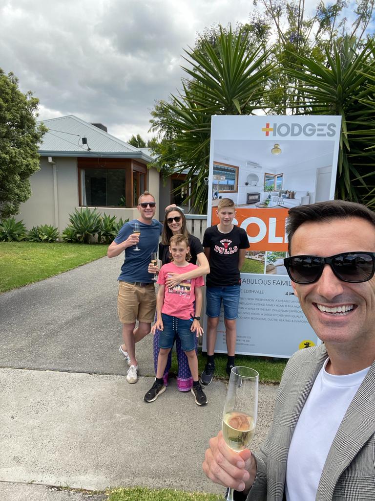 Industry Insider buyer agent celebrating with their clients in front of the newly bought house