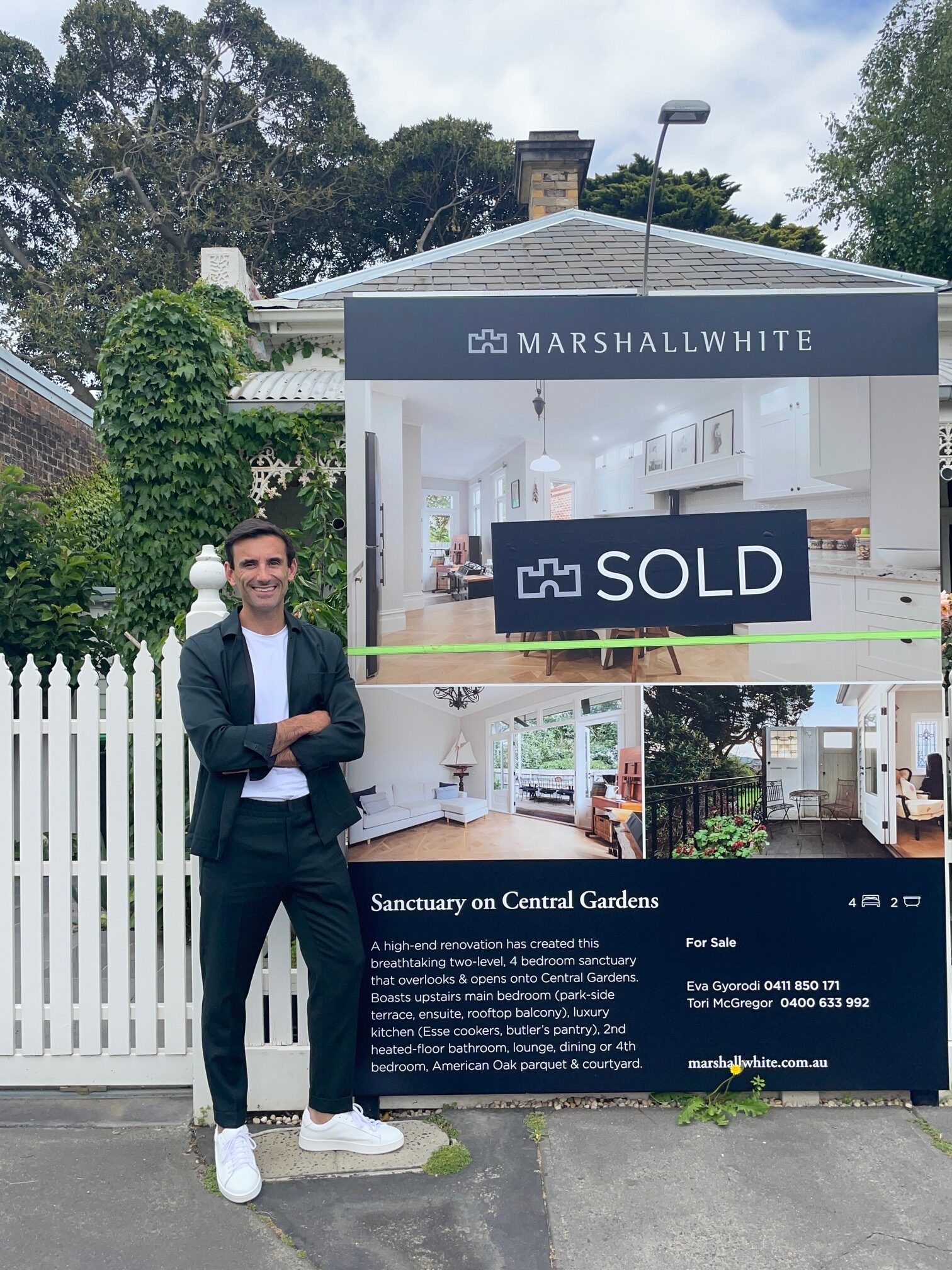 A buyer's advocate standing next to a sold house