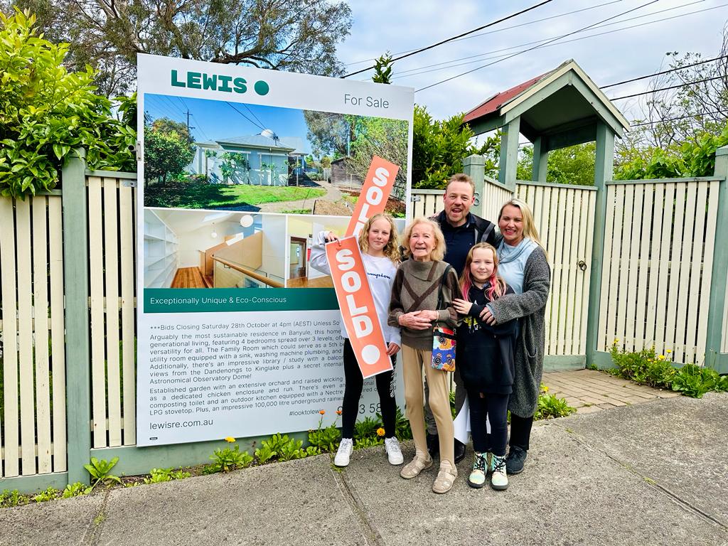 Happy family in front of they newly bought home