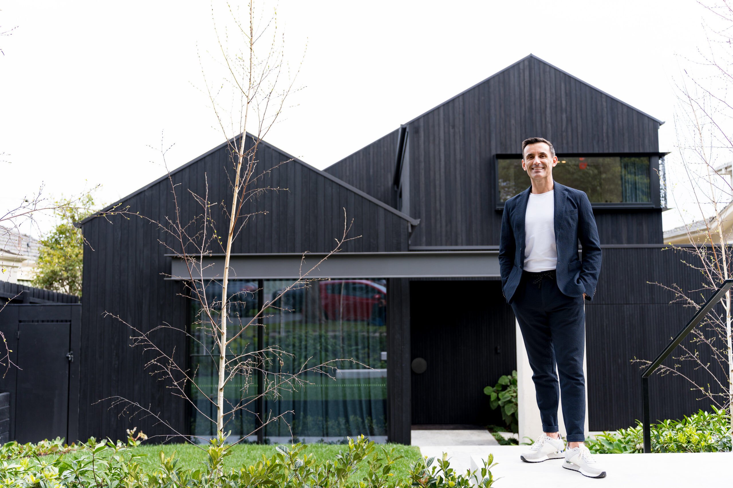 Buyer agent in Melbourne standing in front of a house